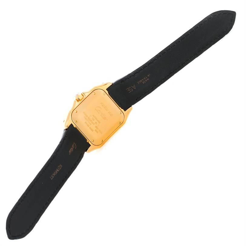 The image shows the back view of a Santos watch by Cartier, featuring its case back and straps.