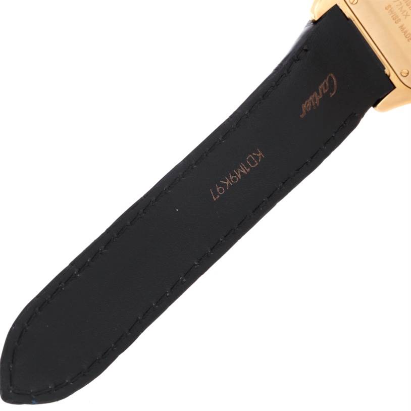 This image shows a close-up of the leather strap and buckle of a Cartier Santos WM502051 Yellow Gold Silver Dial WM502051 Yellow Gold Silver Dial watch.