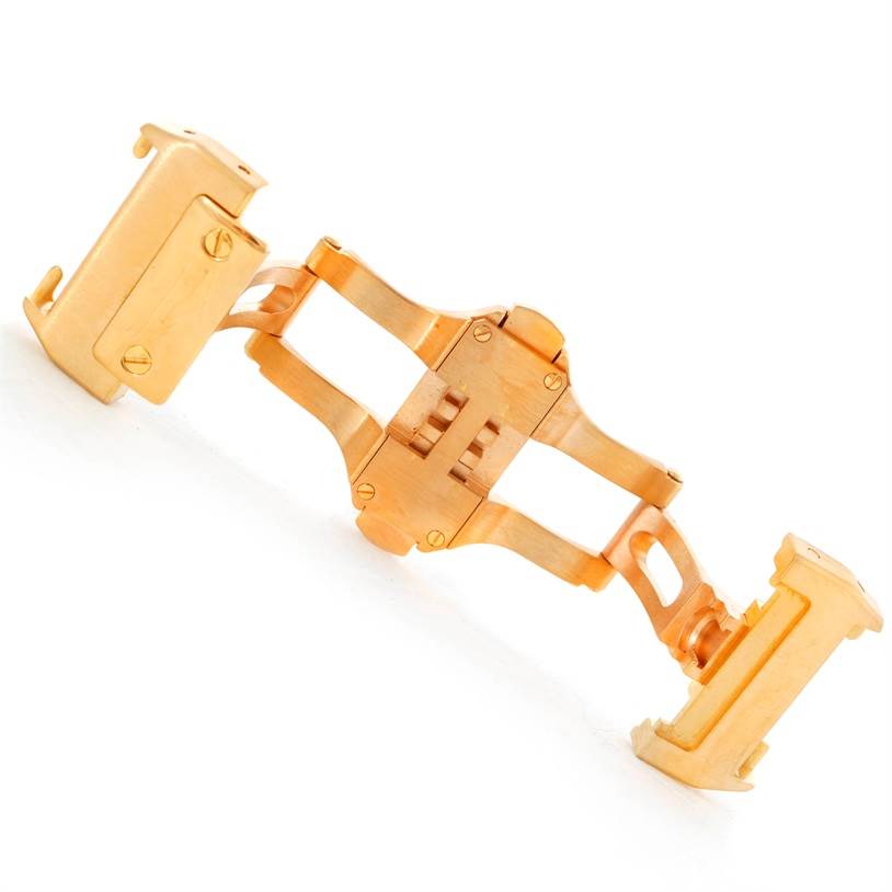 This image shows the deployment clasp of a Cartier Santos WM502051 Yellow Gold Silver Dial WM502051 Yellow Gold Silver Dial watch, viewed from an angled top-down perspective.