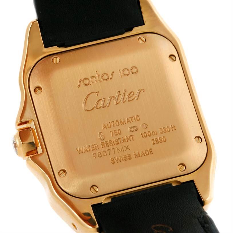The image shows the case back of the Santos model watch by Cartier, highlighting its inscriptions and metal components.