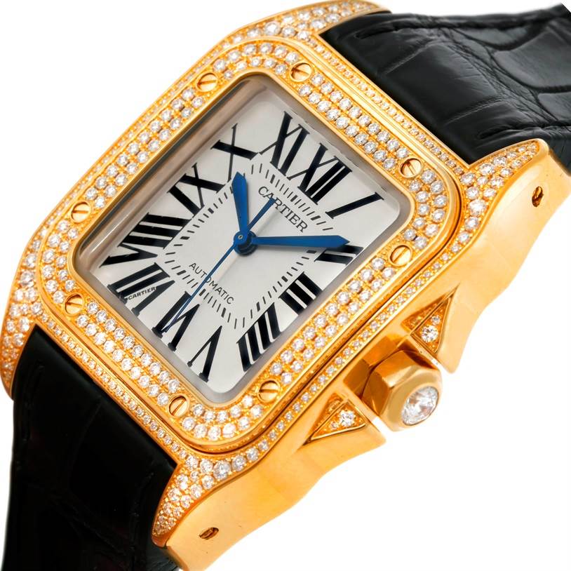 The image shows a close-up angle of the Cartier Santos WM502051 Yellow Gold Silver Dial WM502051 Yellow Gold Silver Dial watch, highlighting its diamond-studded bezel, crown, and black strap.