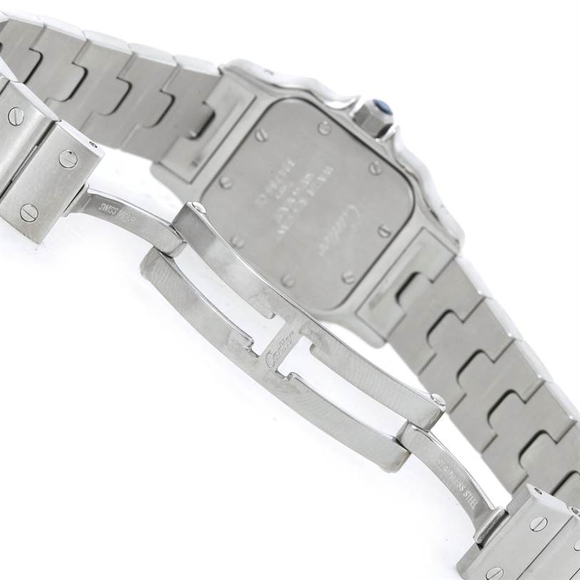 The image shows the back of a Cartier Santos W20056D6 Women
s Stainless Steel Silver Dial W20056D6 Women
s Stainless Steel Silver Dial watch, focusing on the case back and the clasp of the metal bracelet.