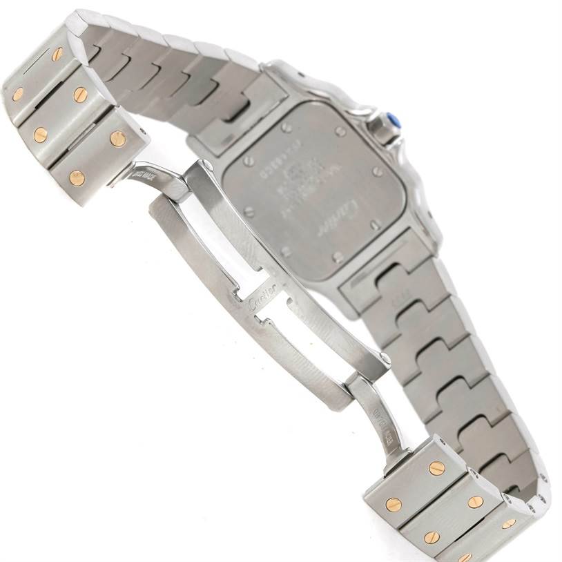 The image shows the back view and bracelet of a Santos watch by Cartier, focusing on the clasp and watch case back.