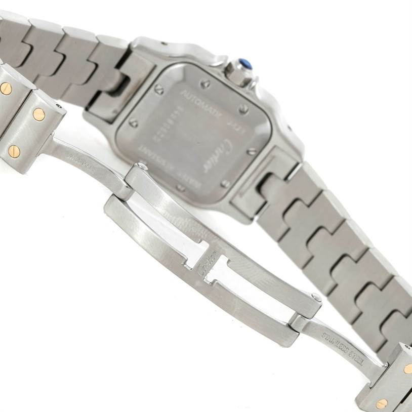 The image shows the back of the Cartier Santos W20057C4 Women
s Stainless Steel Silver Dial W20057C4 Women
s Stainless Steel Silver Dial watch, featuring its case back and part of its metal bracelet and clasp.