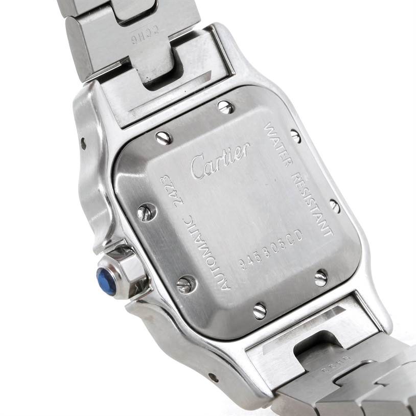 This image shows the back case of a Cartier Santos W20057C4 Women
s Stainless Steel Silver Dial W20057C4 Women
s Stainless Steel Silver Dial watch, displaying its screws, brand engraving, and linked bracelet.