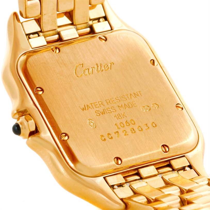 The image shows the back and the bracelet of a Cartier Panthere W25014B9 Yellow Gold Silver Dial W25014B9 Yellow Gold Silver Dial watch, highlighting its gold casing and engravings.