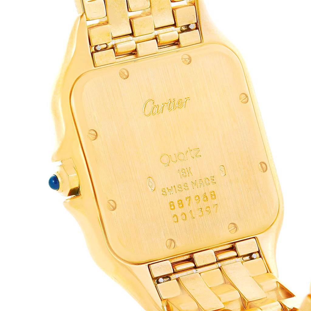 This image shows the back case and part of the bracelet of a Cartier Panthere W25014B9 Men's Yellow Gold Silver Dial W25014B9 Men's Yellow Gold Silver Dial watch, highlighting its inscriptions and quartz movement.