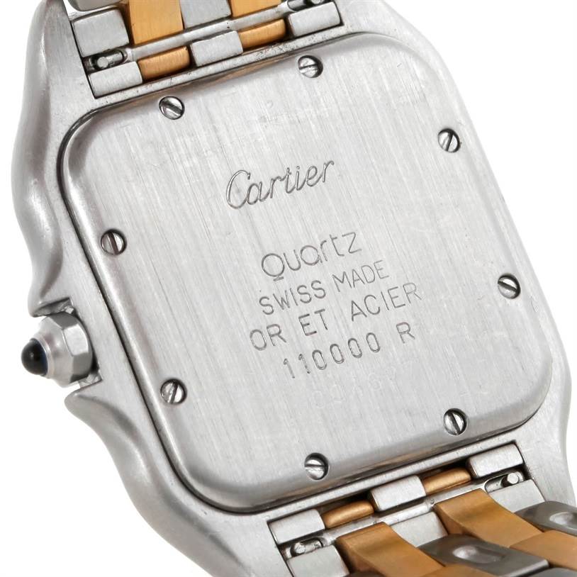 This image shows the back case and part of the bracelet of a Cartier Panthere W25028B6 Steel and Gold (two tone) Silver Dial W25028B6 Steel and Gold (two tone) Silver Dial model watch, along with some engraved details.