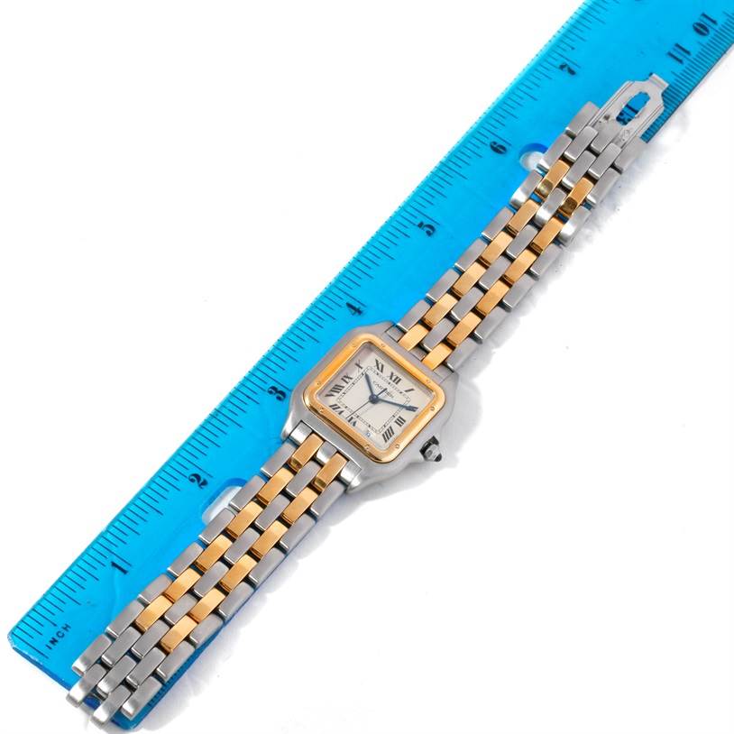 The image shows a top-down view of a Cartier Panthere W25028B6 Steel and Gold (two tone) Silver Dial W25028B6 Steel and Gold (two tone) Silver Dial watch, placed alongside a blue ruler.