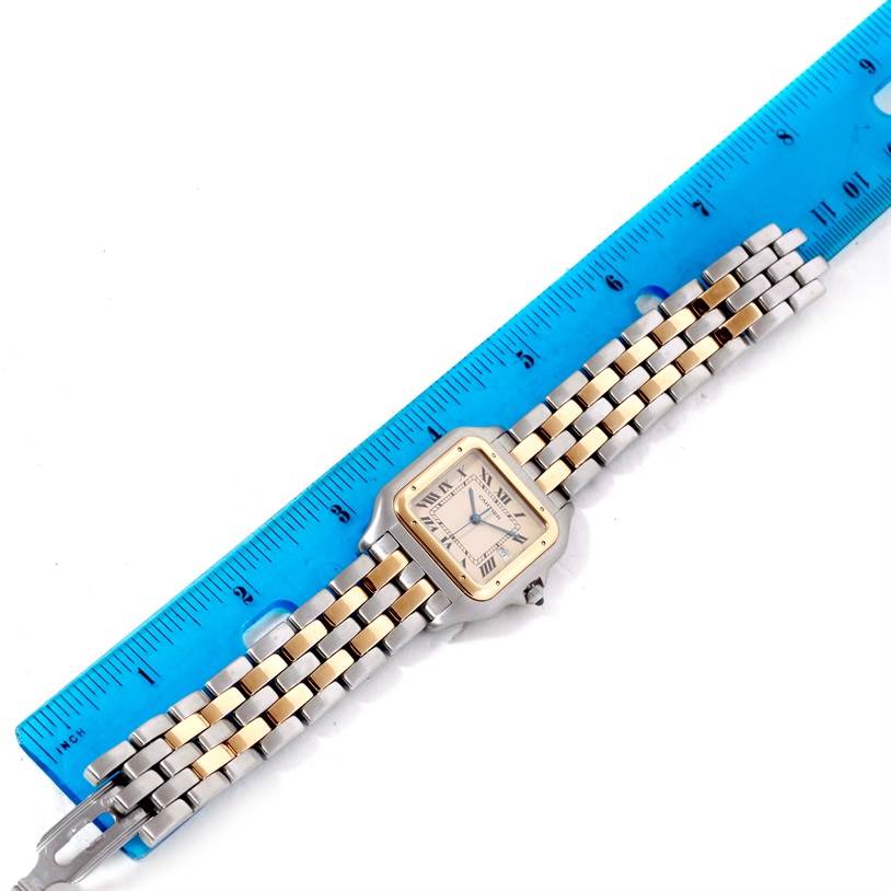 The image shows a Cartier Panthere Men's Steel and Gold (two tone) Beige Dial Men's Steel and Gold (two tone) Beige Dial watch laid flat next to a blue ruler, displaying the face and band.
