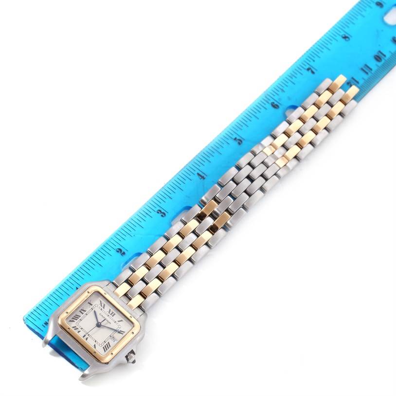The image shows a Panthère de Cartier watch placed next to a ruler, revealing its face and part of the band.