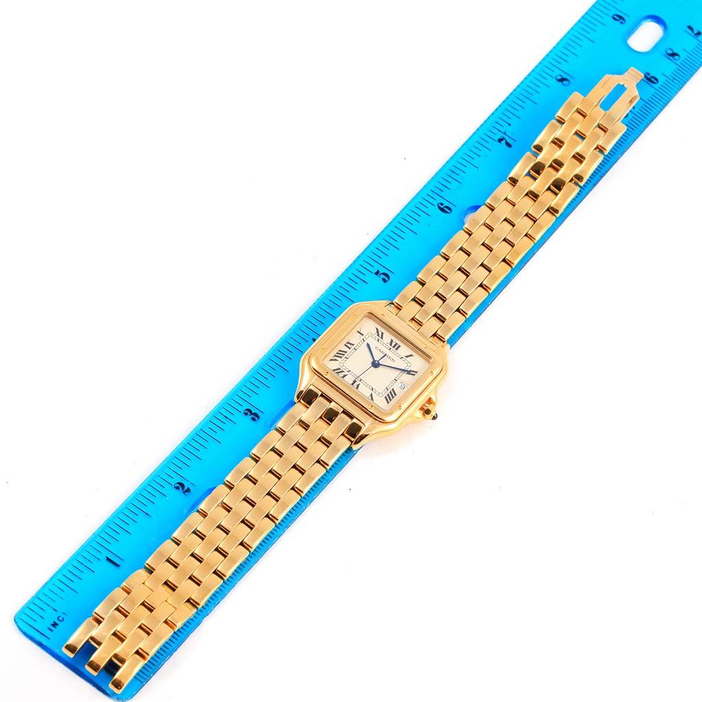 The Cartier Panthere W25014B9 Yellow Gold Silver Dial W25014B9 Yellow Gold Silver Dial watch is shown from a top view, displaying the face, bezel, and bracelet, with a ruler beside it for scale.