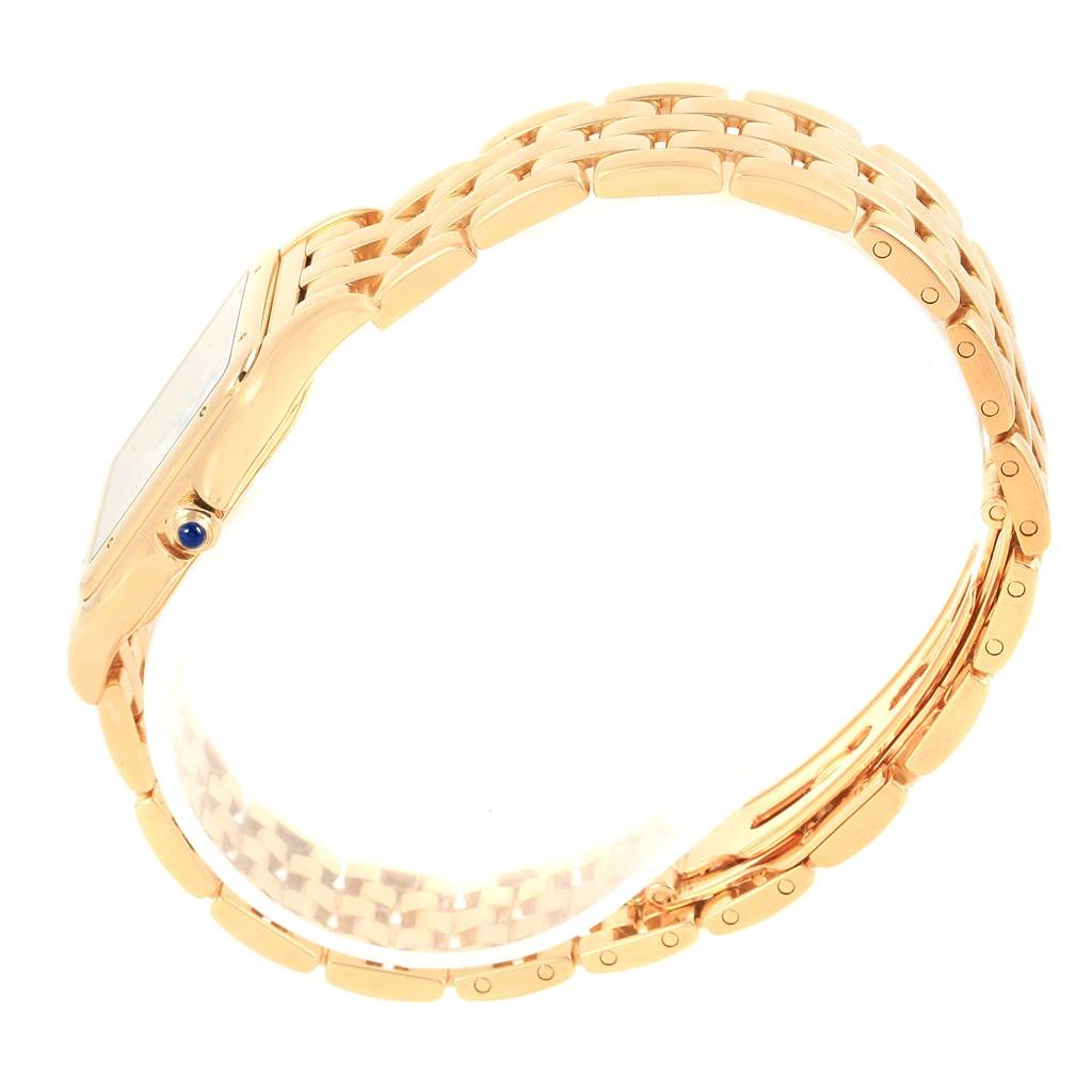 This image shows a side view of a gold Cartier Panthere W25014B9 Yellow Gold Silver Dial W25014B9 Yellow Gold Silver Dial watch, highlighting its band and crown with a blue cabochon.