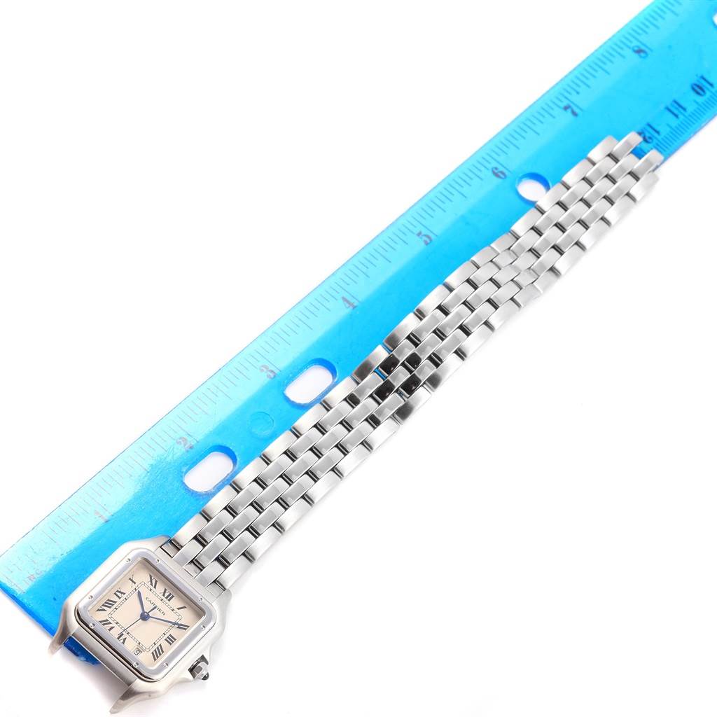The image shows the Cartier Panthere W25054P5 Stainless Steel Silver Dial W25054P5 Stainless Steel Silver Dial watch placed next to a blue ruler for measurement, highlighting its face and metal band.