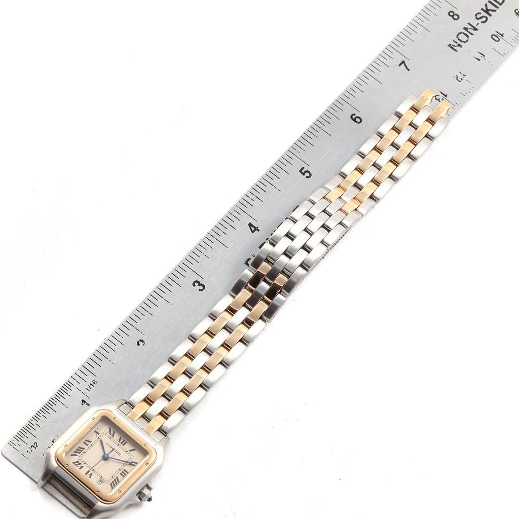 The Cartier Panthere W25028B8 Steel and Gold (two tone) Beige Dial W25028B8 Steel and Gold (two tone) Beige Dial watch is shown from a top-down angle with its face and a portion of the band next to a ruler.