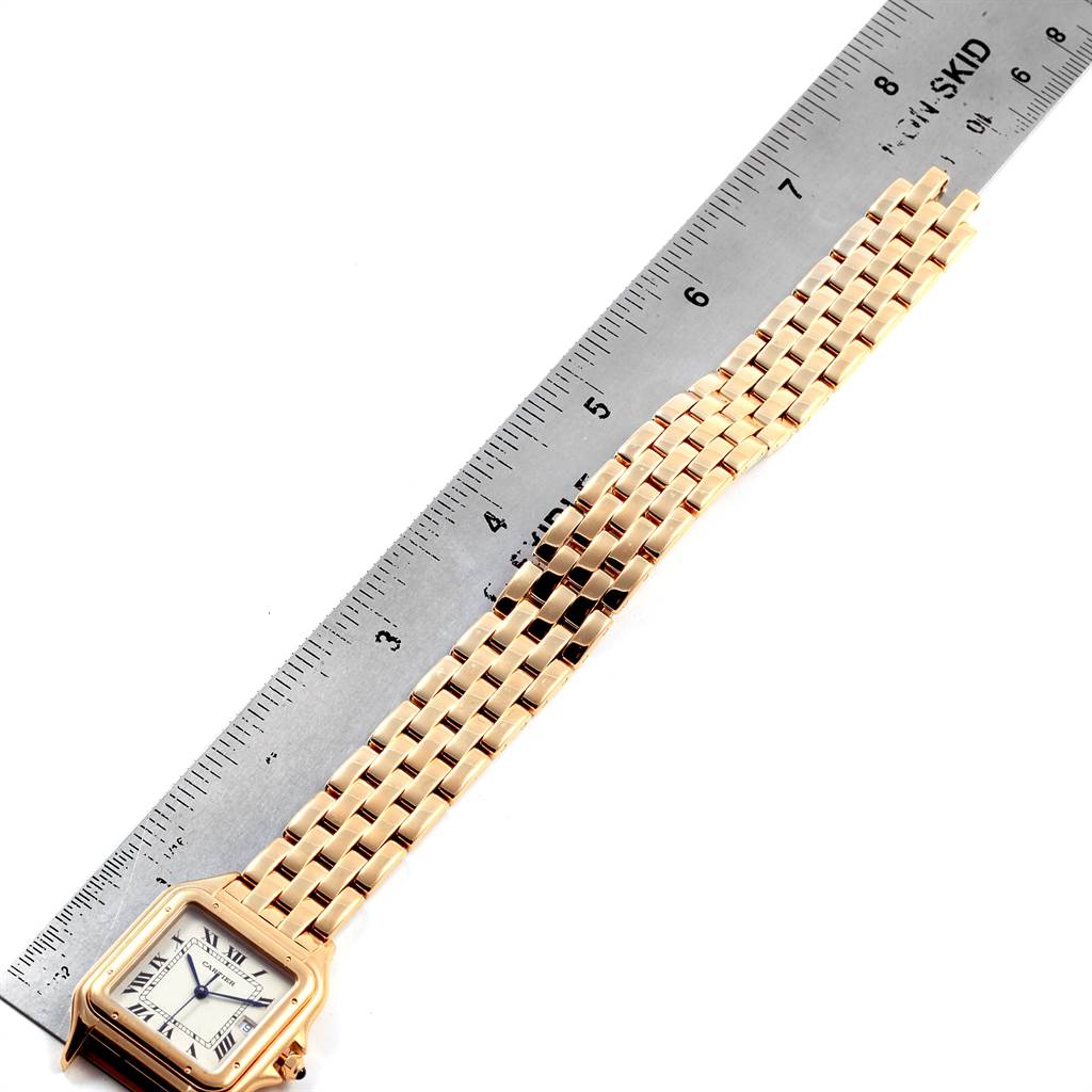 The image shows the front angle of the Cartier Panthere W25014B9 Men's Yellow Gold Silver Dial W25014B9 Men's Yellow Gold Silver Dial model watch with its gold bracelet being measured by a ruler.