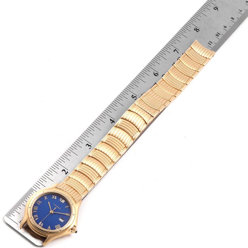 The Cartier Panthere W35019L3 Women's Yellow Gold Blue Dial W35019L3 Women's Yellow Gold Blue Dial watch is shown from an above angle, displaying its blue dial and gold bracelet beside a ruler.