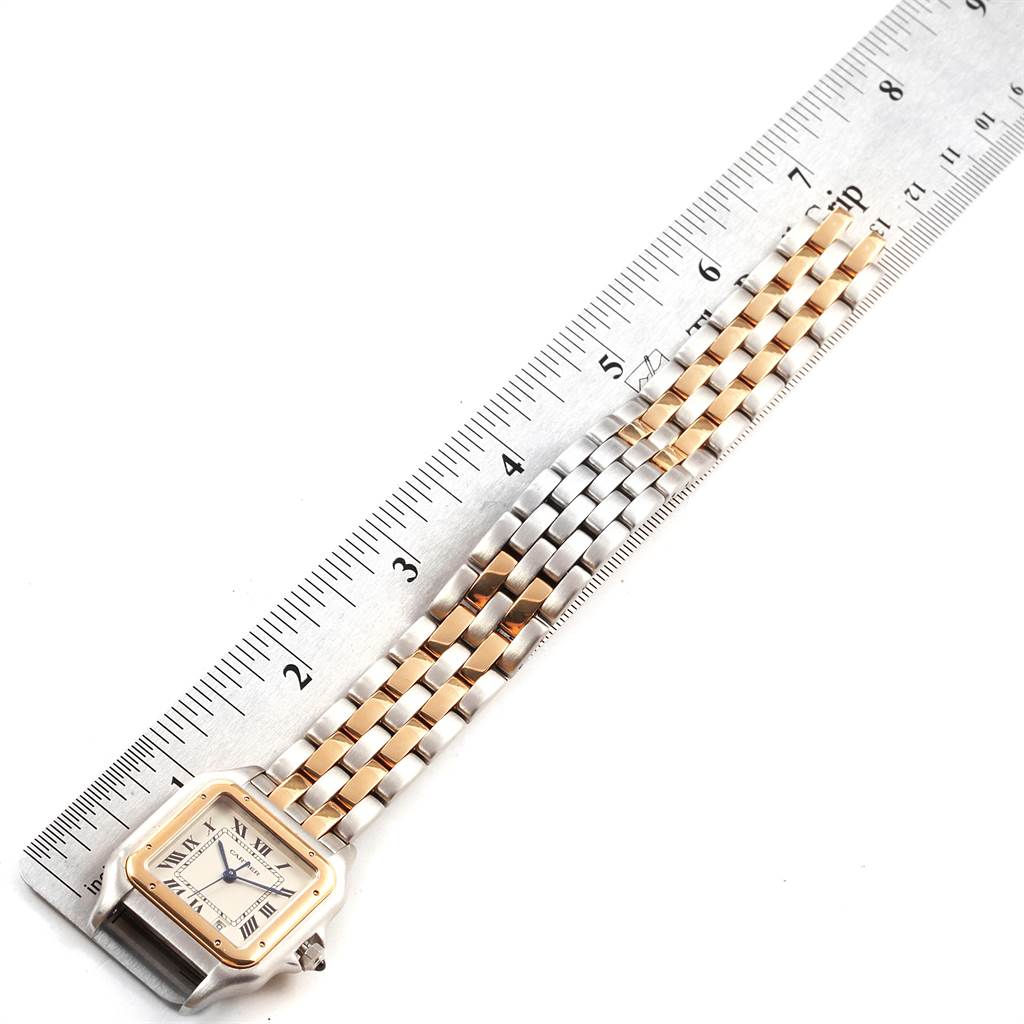 The image shows a top-down view of a Cartier Panthere W25028B8 Steel and Gold (two tone) Silver Dial W25028B8 Steel and Gold (two tone) Silver Dial watch, highlighting its two-tone bracelet and face next to a ruler.