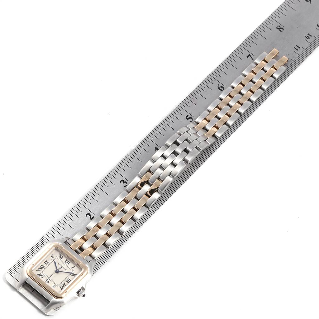 The image shows the Panthere de Cartier watch laid flat, with a ruler measuring its length and showcasing its bracelet.