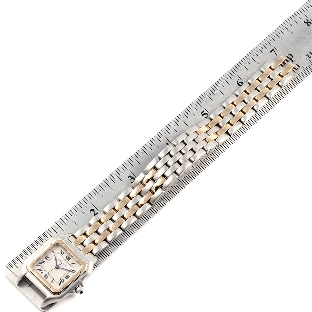 The image shows the Panthère model watch by Cartier laid flat on a ruler, displaying its square face and two-tone metal bracelet.