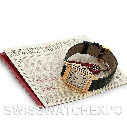 The image shows a Cartier Panthere Yellow Gold White Dial Yellow Gold White Dial watch laid on its international guarantee certificate, viewed from an angled top-down perspective.