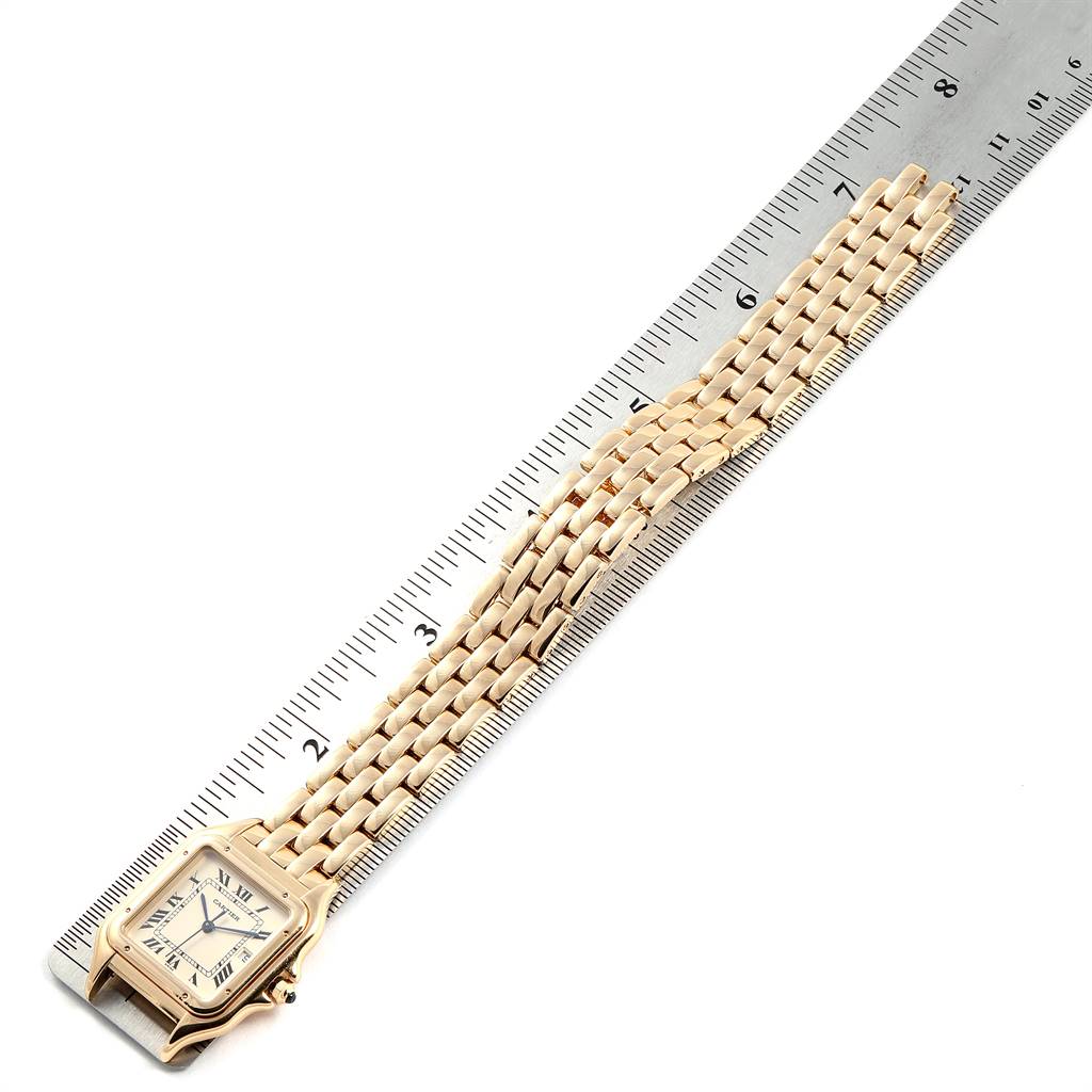This image shows a Cartier Panthere W25014B9 Men's Yellow Gold Silver Dial W25014B9 Men's Yellow Gold Silver Dial watch flat on a ruler, displaying its face and full gold-tone link bracelet.