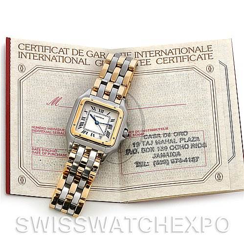 The image shows a Cartier Panthere Yellow Gold Beige Dial Yellow Gold Beige Dial watch placed on an open international guarantee certificate, displaying both the watch face and part of the bracelet.