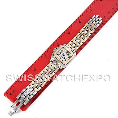 The image shows a Panthere model by Cartier placed horizontally against a red ruler, displaying its face and full two-tone bracelet.