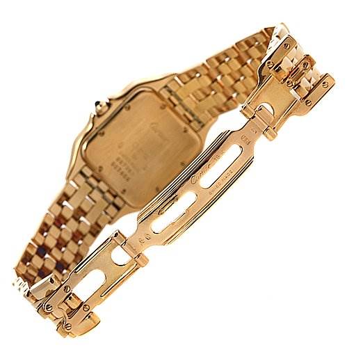 This image shows the back side and clasp of a Cartier Panthere Yellow Gold Silver Dial Yellow Gold Silver Dial watch, showcasing its gold bracelet and engraved case back.