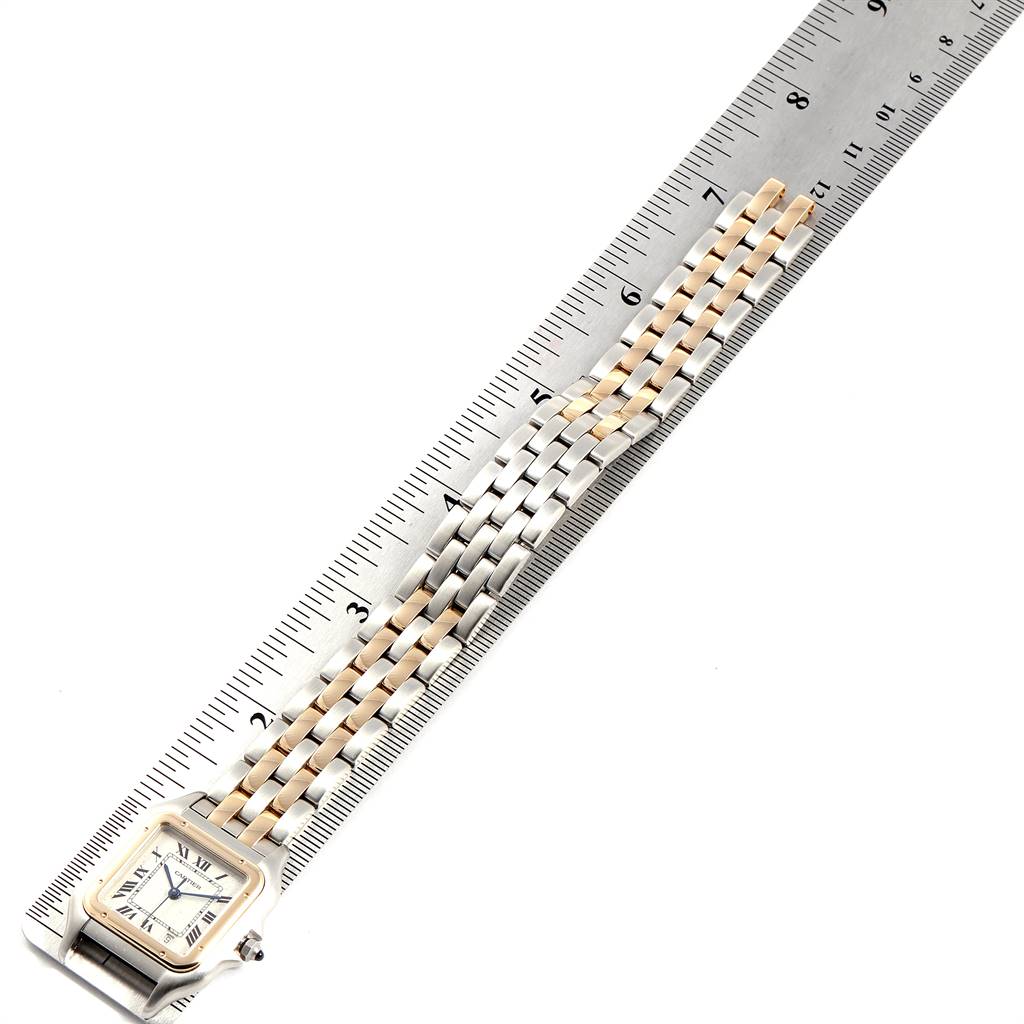 The image shows a Panthere de Cartier watch with its face and two-tone metal strap, placed beside a ruler.