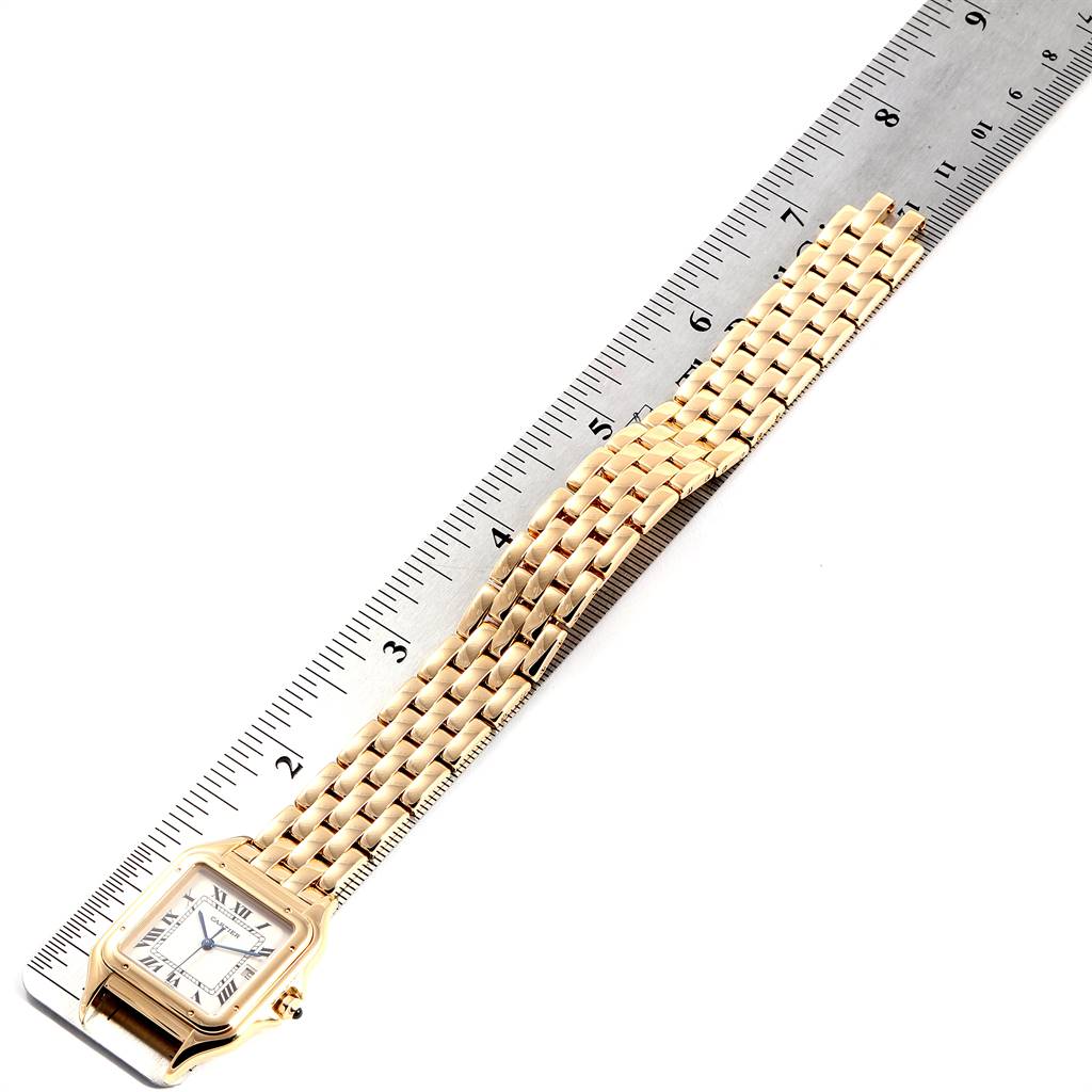 The Cartier Panthère watch is shown at an angle displaying the face and full length of the band next to a ruler for scale.