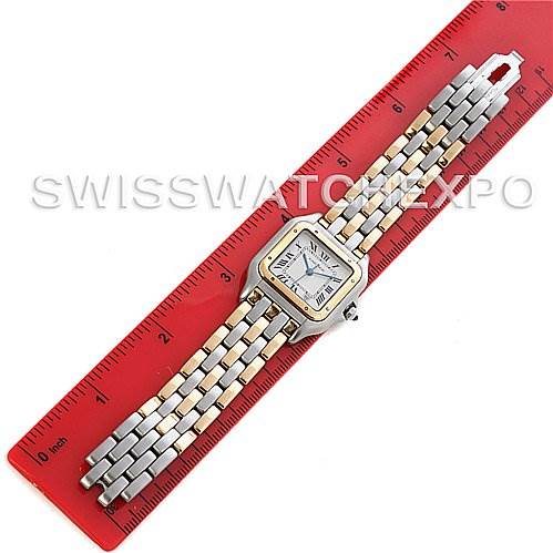 This image shows a top-down view of a Cartier Panthere Steel and Gold (two tone) Silver Dial Steel and Gold (two tone) Silver Dial model watch placed on a red ruler.
