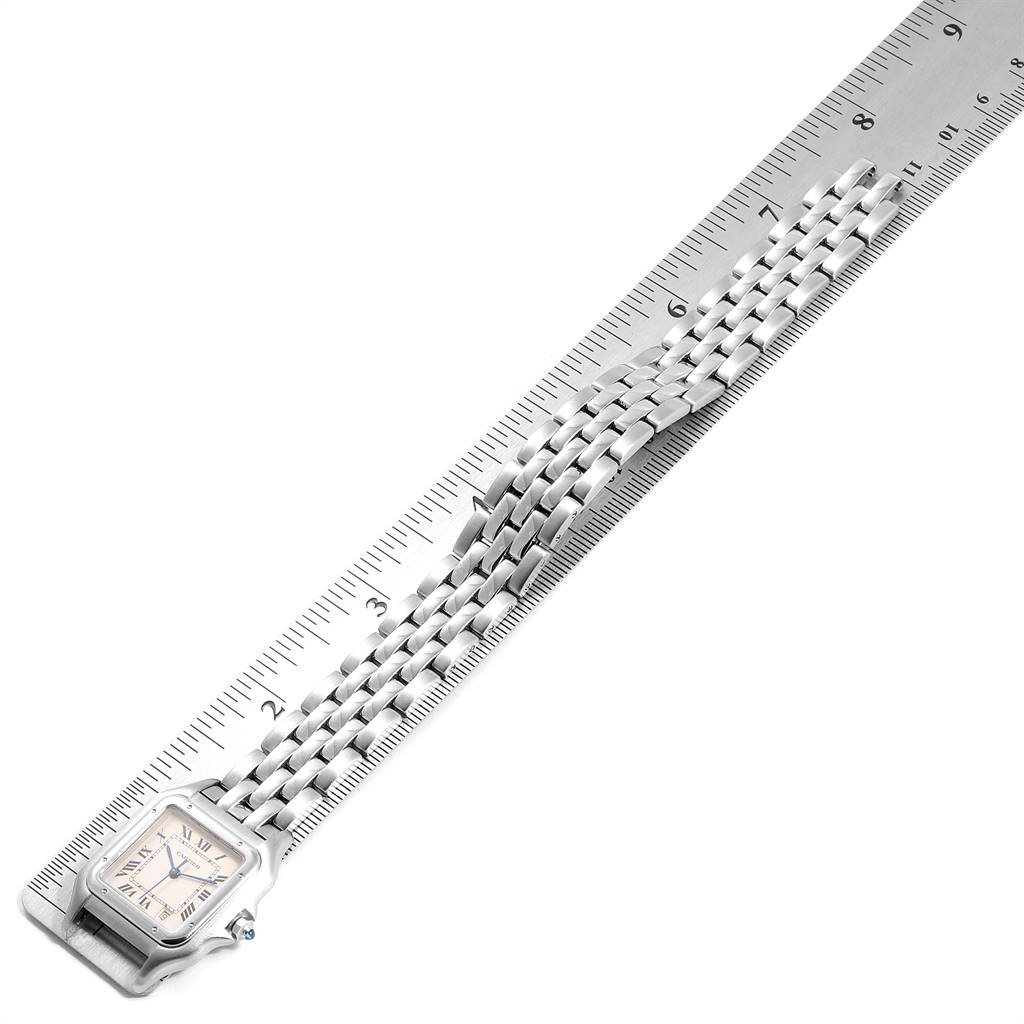 The image shows the Panthere model by Cartier laid flat, with a ruler measuring its length, highlighting the watch face and band.