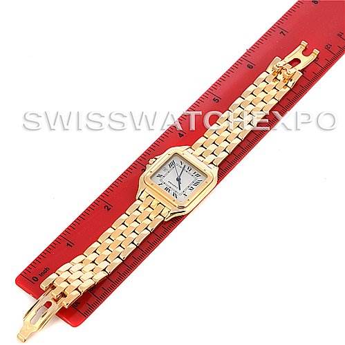 The image shows a full view of a Cartier Panthere Yellow Gold Silver Dial Yellow Gold Silver Dial watch, including the watch face and gold bracelet, placed on a red ruler for scale.