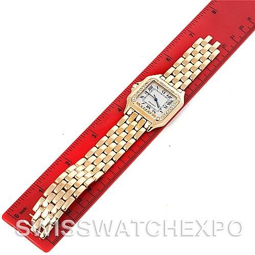 The image shows a top-down view of a Cartier Panthere Yellow Gold Silver Dial Yellow Gold Silver Dial watch placed on a red ruler.