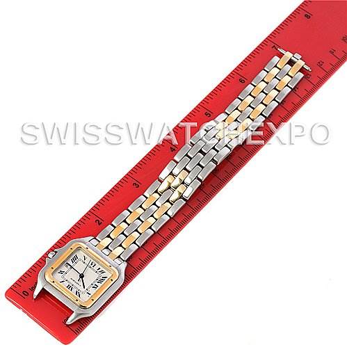 The Cartier Panthere Steel and Gold (two tone) Silver Dial Steel and Gold (two tone) Silver Dial watch is shown horizontally with its face and full metal bracelet alongside a red ruler.