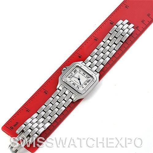 The Cartier Panthere W25032P5 Men
s Stainless Steel Silver Dial W25032P5 Men
s Stainless Steel Silver Dial watch is shown lying flat alongside a red ruler, displaying its face and metal bracelet.
