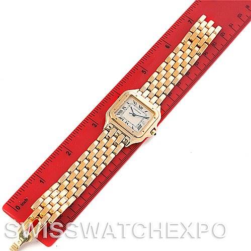 The image shows a top-down view of a gold Panthere de Cartier watch placed on a red ruler for measurement.