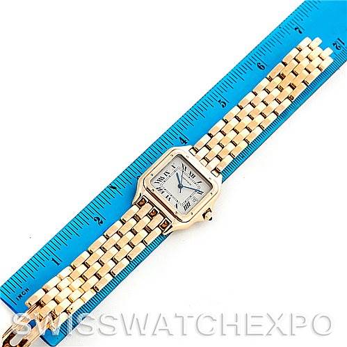 The Cartier Panthere W25014B9 Men
s Silver Dial W25014B9 Men
s Silver Dial watch is shown from a top-down angle, displaying the face, bezel, and entire bracelet alongside a ruler for scale.