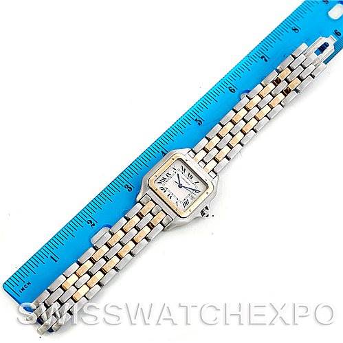 The image shows the Panthere model by Cartier from a top-down angle, including the watch face and full metal bracelet next to a blue ruler.