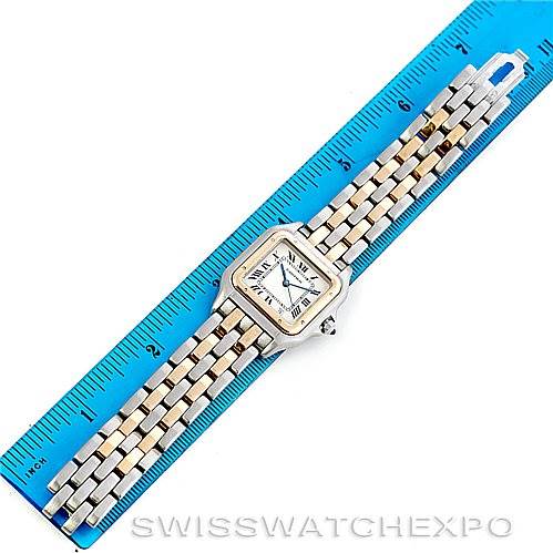 This image shows a top view of a Cartier Panthere W25028B6 Men's Steel and Gold (two tone) Beige Dial W25028B6 Men's Steel and Gold (two tone) Beige Dial watch, highlighting its face and bracelet against a blue ruler for scale.