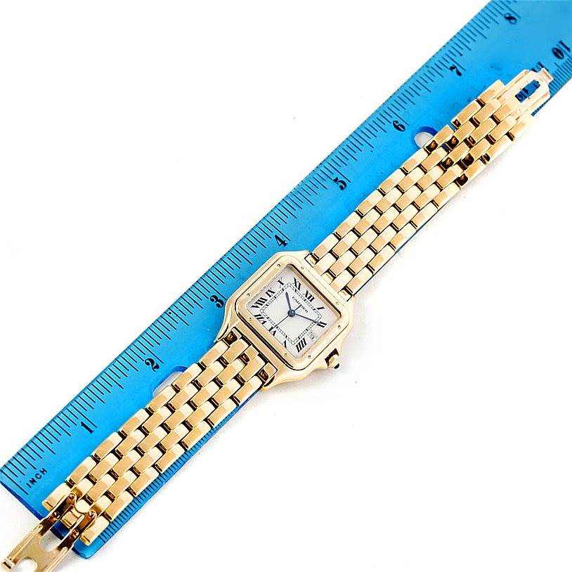 The image shows a top view of a Panthere model by Cartier placed alongside a blue ruler.