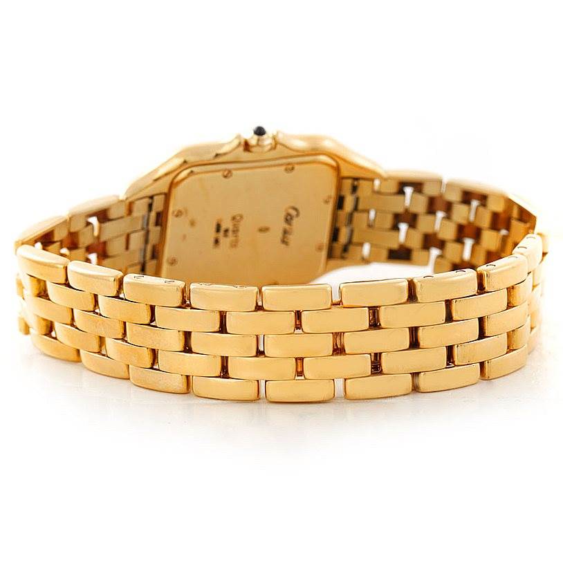 The image shows the backside and bracelet of a Panthere model watch by Cartier, highlighting the gold links and case back.