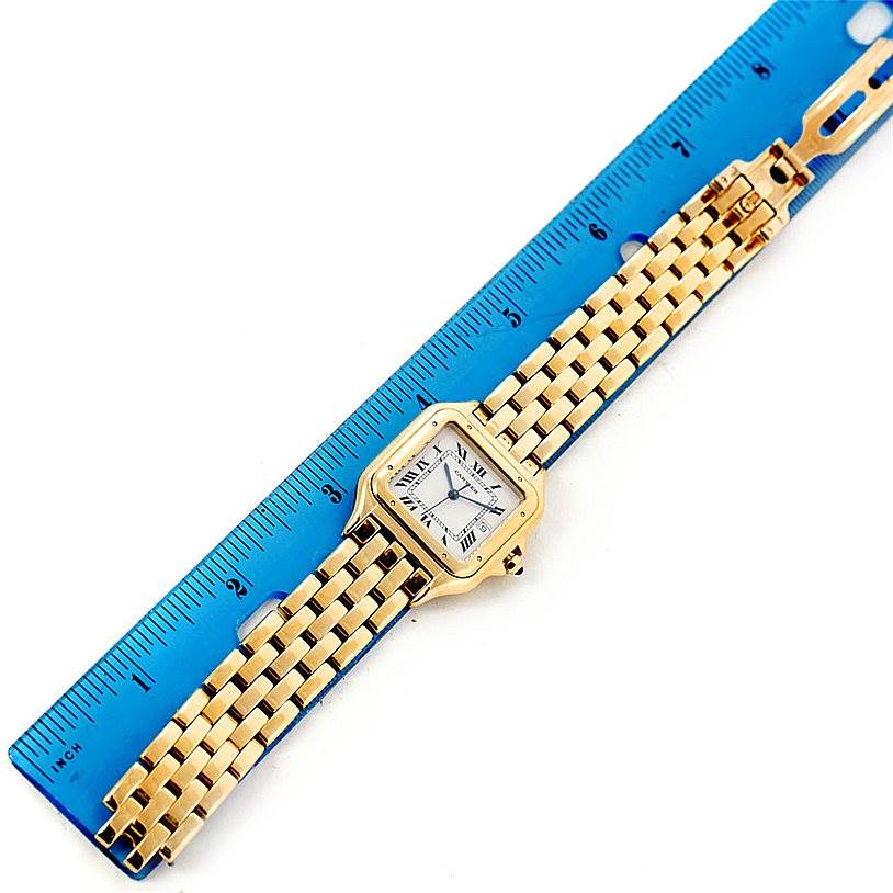 The image shows an aerial view of a Cartier Panthere W25014B9 Men
s Yellow Gold Silver Dial W25014B9 Men
s Yellow Gold Silver Dial watch, fully extended with a ruler for scale.