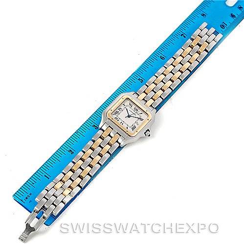 This image shows a top view of the Cartier Panthere Men
s Steel and Gold (two tone) Silver Dial Men
s Steel and Gold (two tone) Silver Dial watch, displaying its face, bracelet, and clasp next to a ruler for scale.