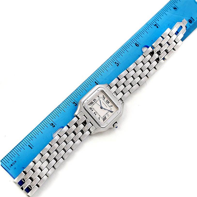 The Panthere model by Cartier is shown from a top-down angle, displaying the entire watch face and bracelet.