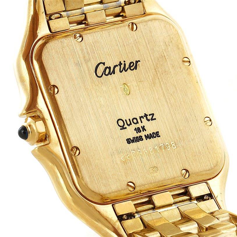 The image shows the back of a gold Cartier Panthere W25014B9 Men's Yellow Gold Silver Dial W25014B9 Men's Yellow Gold Silver Dial watch, showcasing its inscriptions and bracelet attachment.