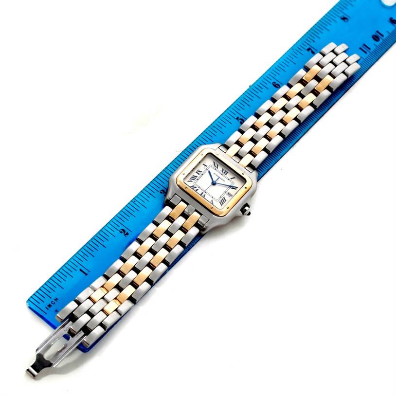 The Cartier Panthere Steel and Gold (two tone) Silver Dial Steel and Gold (two tone) Silver Dial model watch is displayed flat alongside a ruler, showing the face, bezel, and entire metal bracelet.