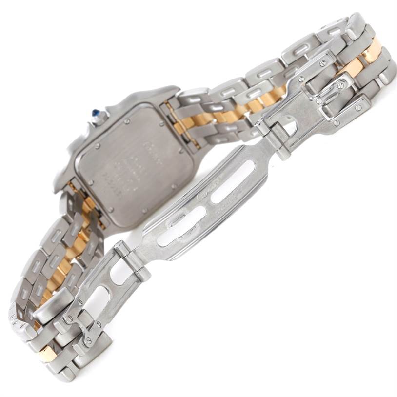 The image shows the underside of a Cartier Panthere W25028B5 Steel and Gold (two tone) Silver Dial W25028B5 Steel and Gold (two tone) Silver Dial watch, highlighting its back case and the partially opened clasp on the metal bracelet.