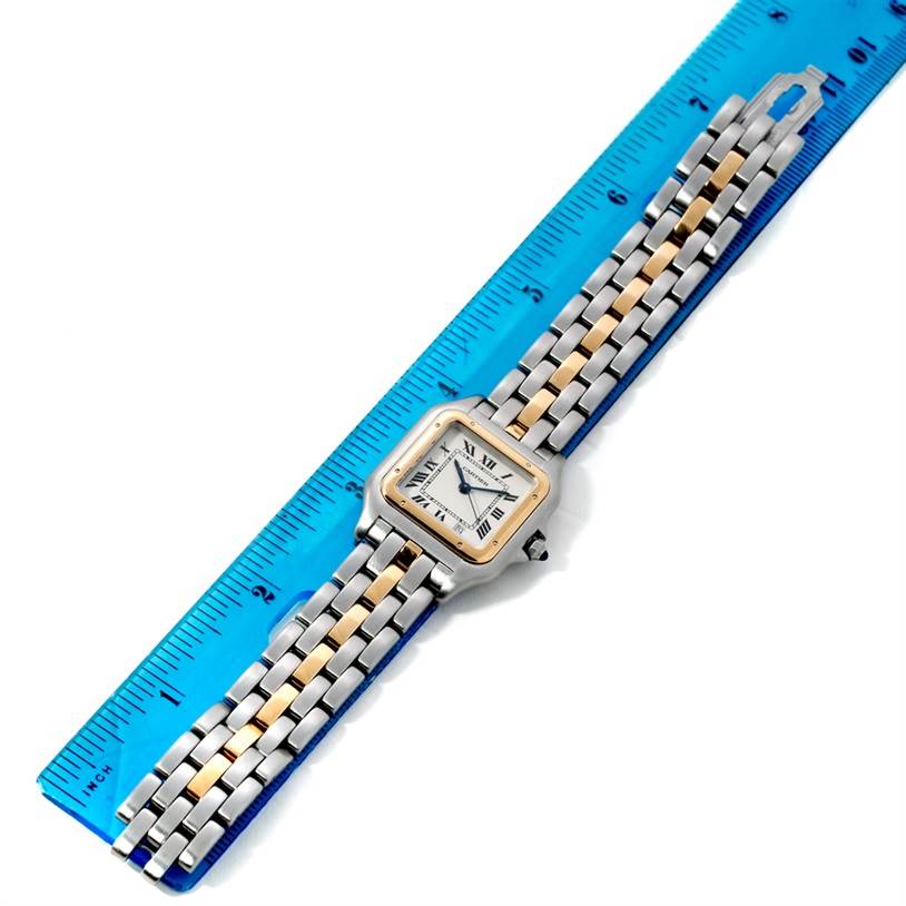 The Cartier Panthere W25028B5 Steel and Gold (two tone) Silver Dial W25028B5 Steel and Gold (two tone) Silver Dial watch is shown from a top-down angle, highlighting the face and bracelet alongside a ruler for scale.